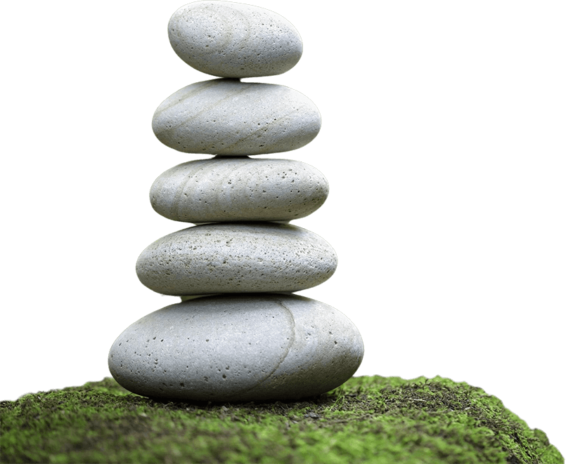 A stack of rocks on top of grass.