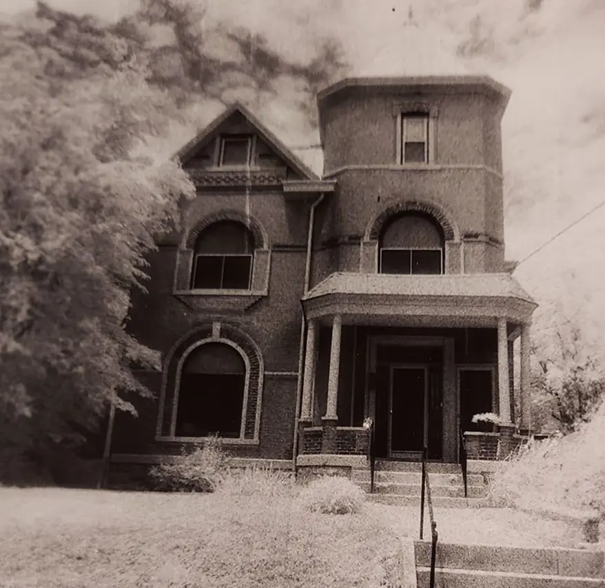 A black and white photo of an old house.